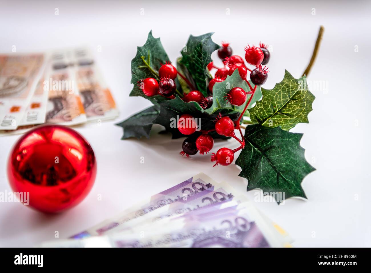 Christmas decorations with bunches of money bank notes isolated. Financial cost of Christmas concept, background. Stock Photo