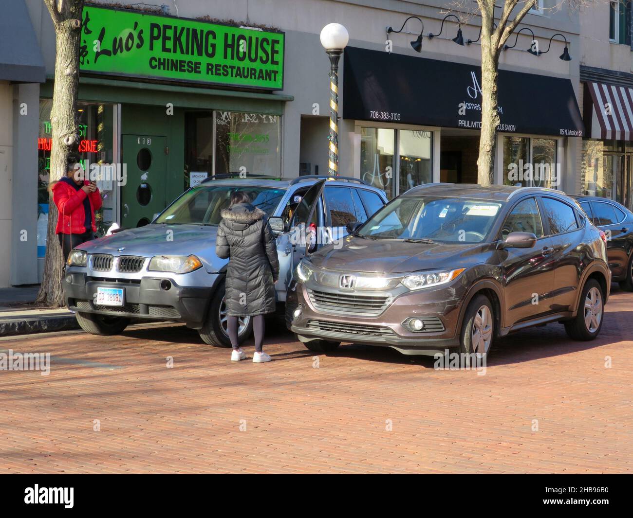 Automobile accident scene. Driver of parked car opened door into