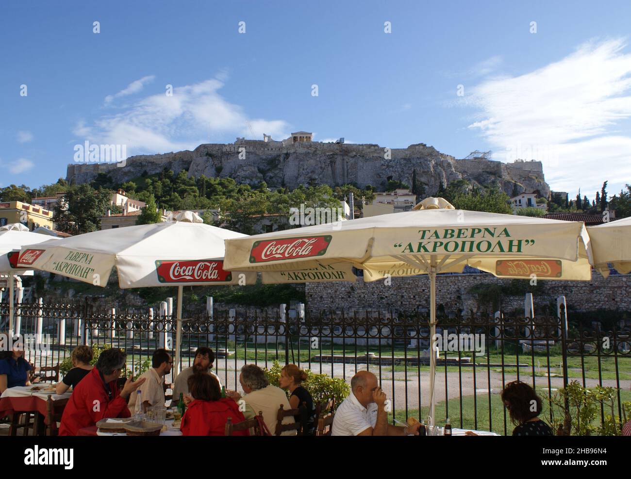 Athens - Greece - September 27 2009 :: Traditional taverna by the Roman Agora, with a view to the classical, historic, ancient Acropolis.   Landscape Stock Photo