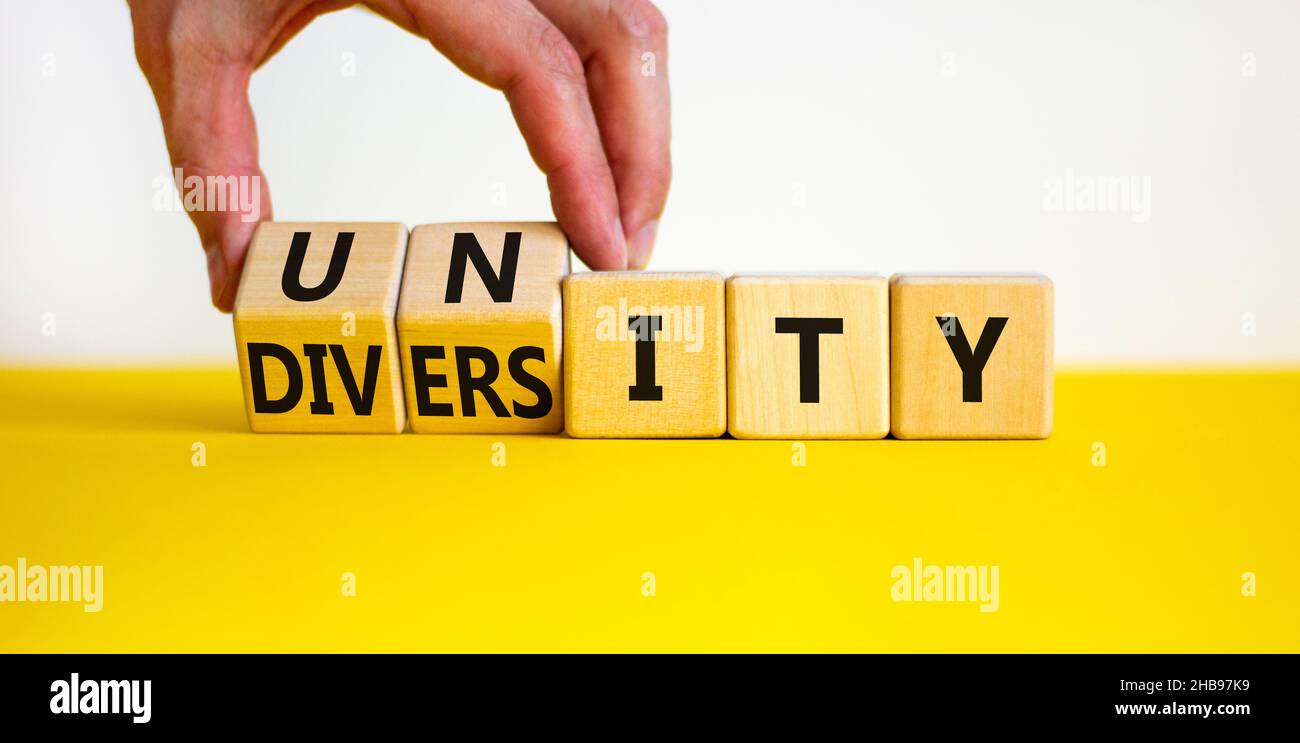 Diversity and unity symbol. Businessman turns wooden cubes and changes ...