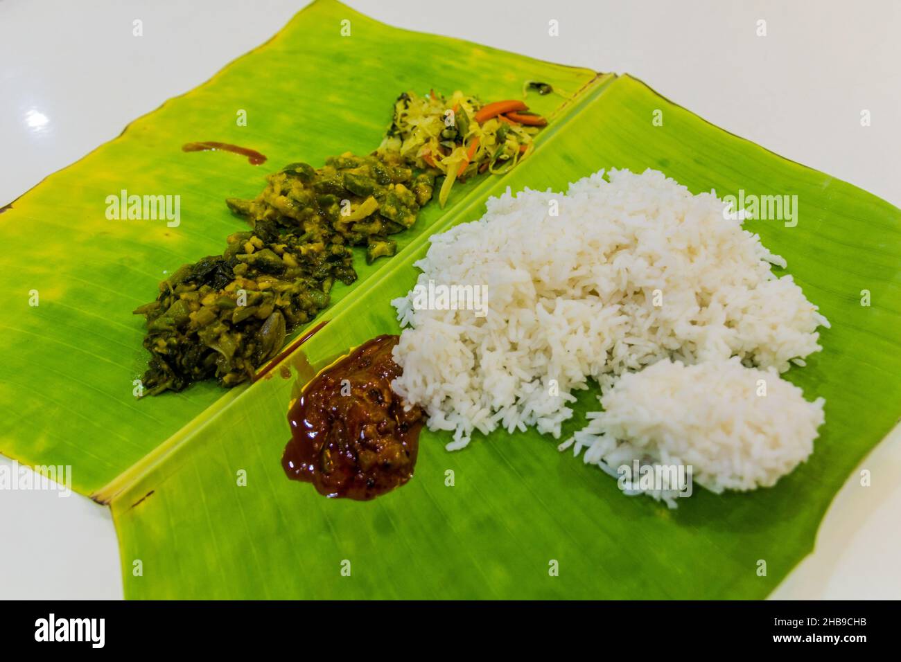 Thali, Indian meal, served on a banana leaf Stock Photo