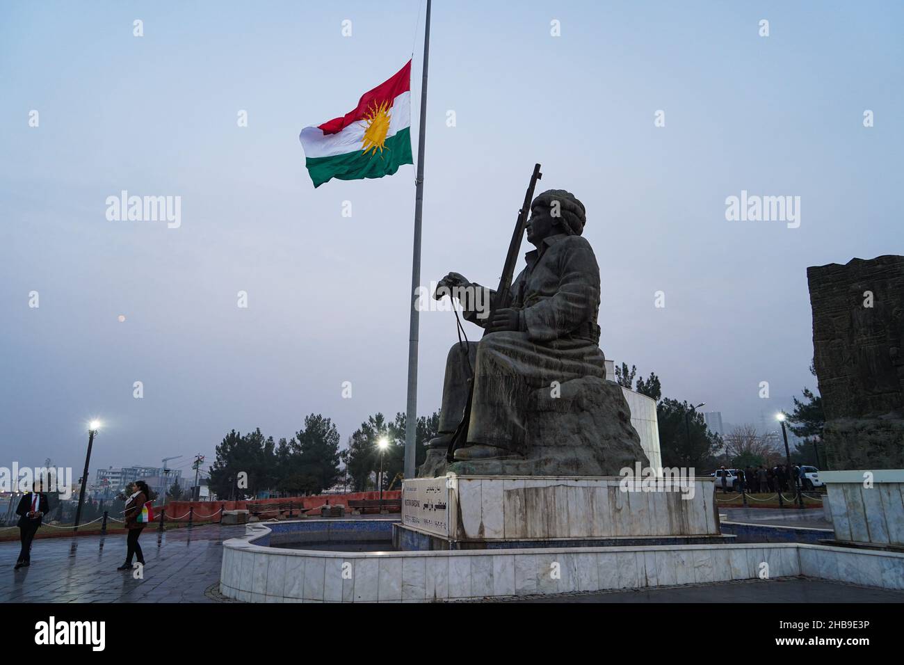 Duhok, Iraq. 17th Dec, 2021. The Kurdistan flag seen waving over a statue of Kurdish leader Mulla Mustafa Barzani, founder of the Kurdistan Democratic Party (KDP), during the festival.In 2009, the Kurdistan Region Parliament declared December 17 to mark the Kurdish national flag day since it was first officially used by the Republic of Kurdistan known as the Republic of Mahabad on December 17, 1946. Credit: SOPA Images Limited/Alamy Live News Stock Photo