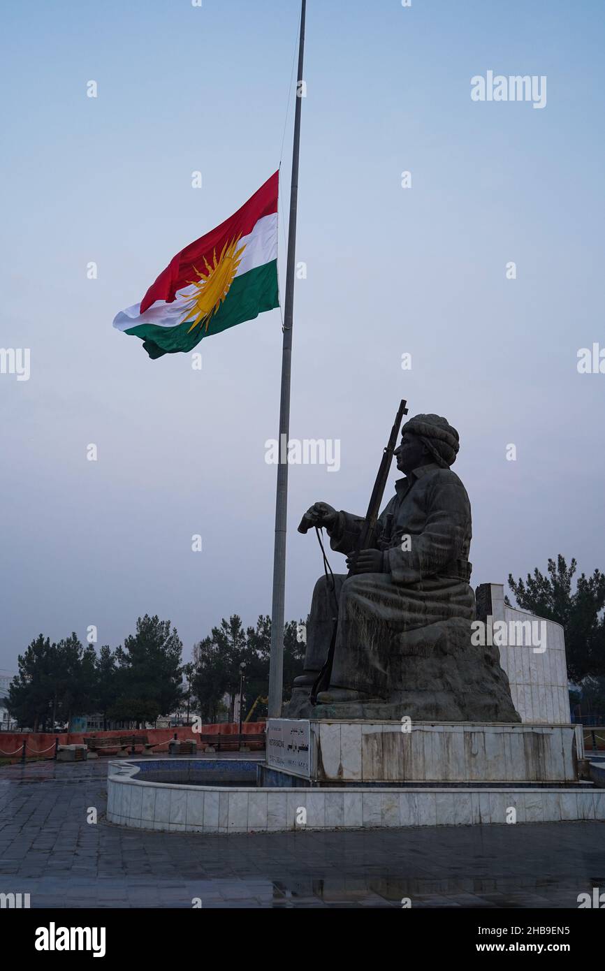 Duhok, Iraq. 17th Dec, 2021. The Kurdistan flag seen waving over a statue of Kurdish leader Mulla Mustafa Barzani, founder of the Kurdistan Democratic Party (KDP), during the festival.In 2009, the Kurdistan Region Parliament declared December 17 to mark the Kurdish national flag day since it was first officially used by the Republic of Kurdistan known as the Republic of Mahabad on December 17, 1946. (Photo by Ismael Adnan/SOPA Images/Sipa USA) Credit: Sipa USA/Alamy Live News Stock Photo