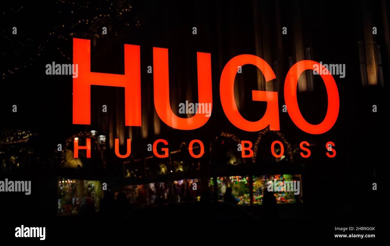 Shop logo of a Hugo Boss designer store with reflection of Christmas market  stands in downtown Düsseldorf/Germany Stock Photo - Alamy