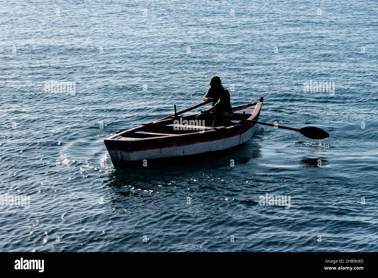 Salvador, Bahia, Brazil - Novembro 12, 2021: Person rowing a boat at sea. Salvador, Bahia, Brazil. Stock Photo