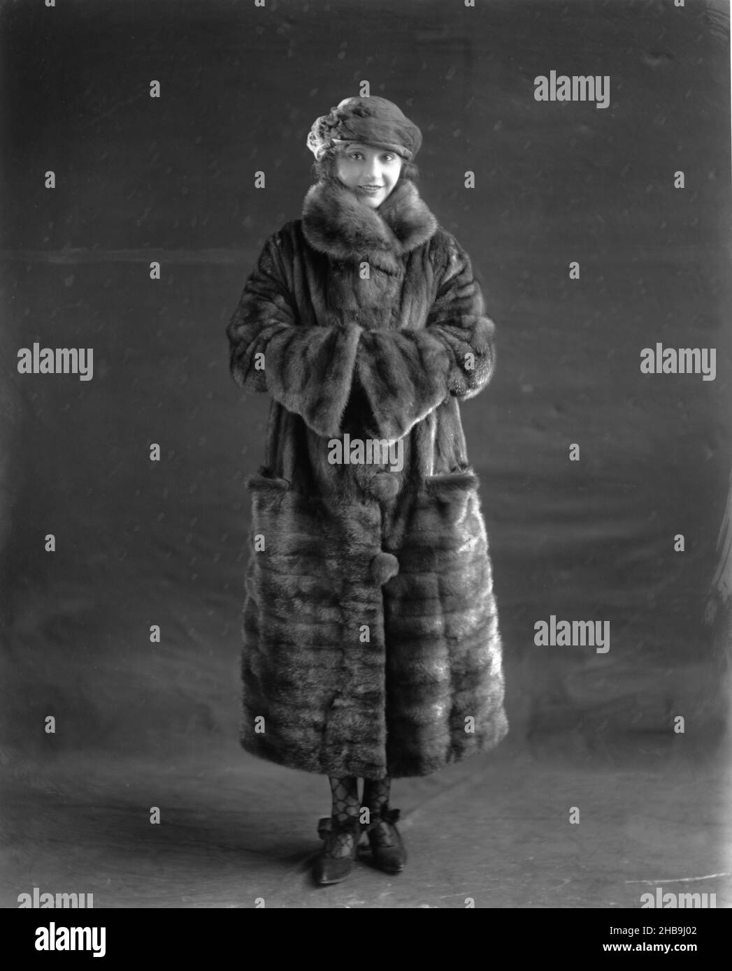 Fur Coat. circa 1929: A fashion model wearing a fur coat