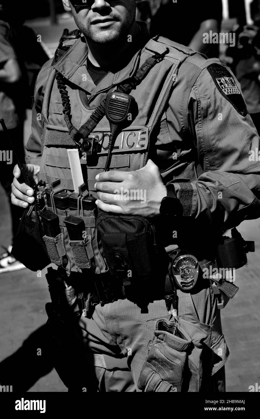 A member of the Santa Fe, New Mexico, SWAT team keeps on eye on the crowd enjoying an outdoor public event. Stock Photo