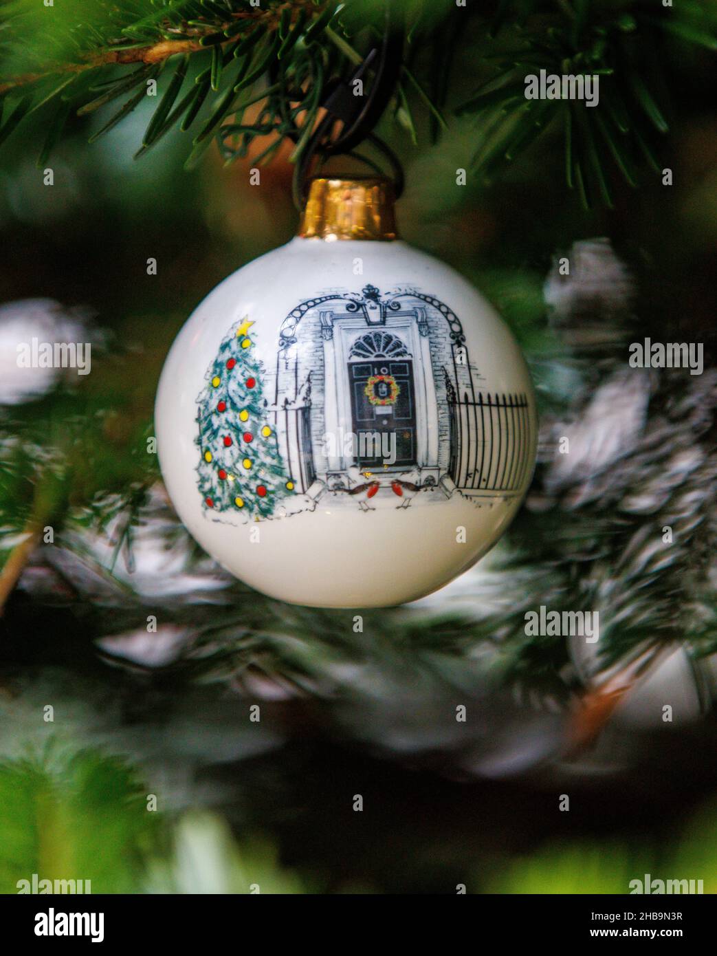 London, UK. 17th Dec, 2021. Detail of a Baubel hanging on the tree outside Number 10 Downing Street. The baubel shows the door of Number 10, 2 robins and a Christmas tree. There is controversy about an alleged Downing Street party. Credit: Tommy London/Alamy Live News Stock Photo