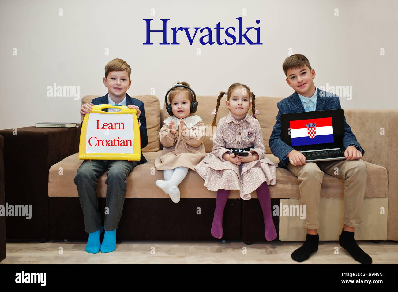 Four kids show inscription learn croatian. Foreign language learning concept. Hrvatski. Stock Photo