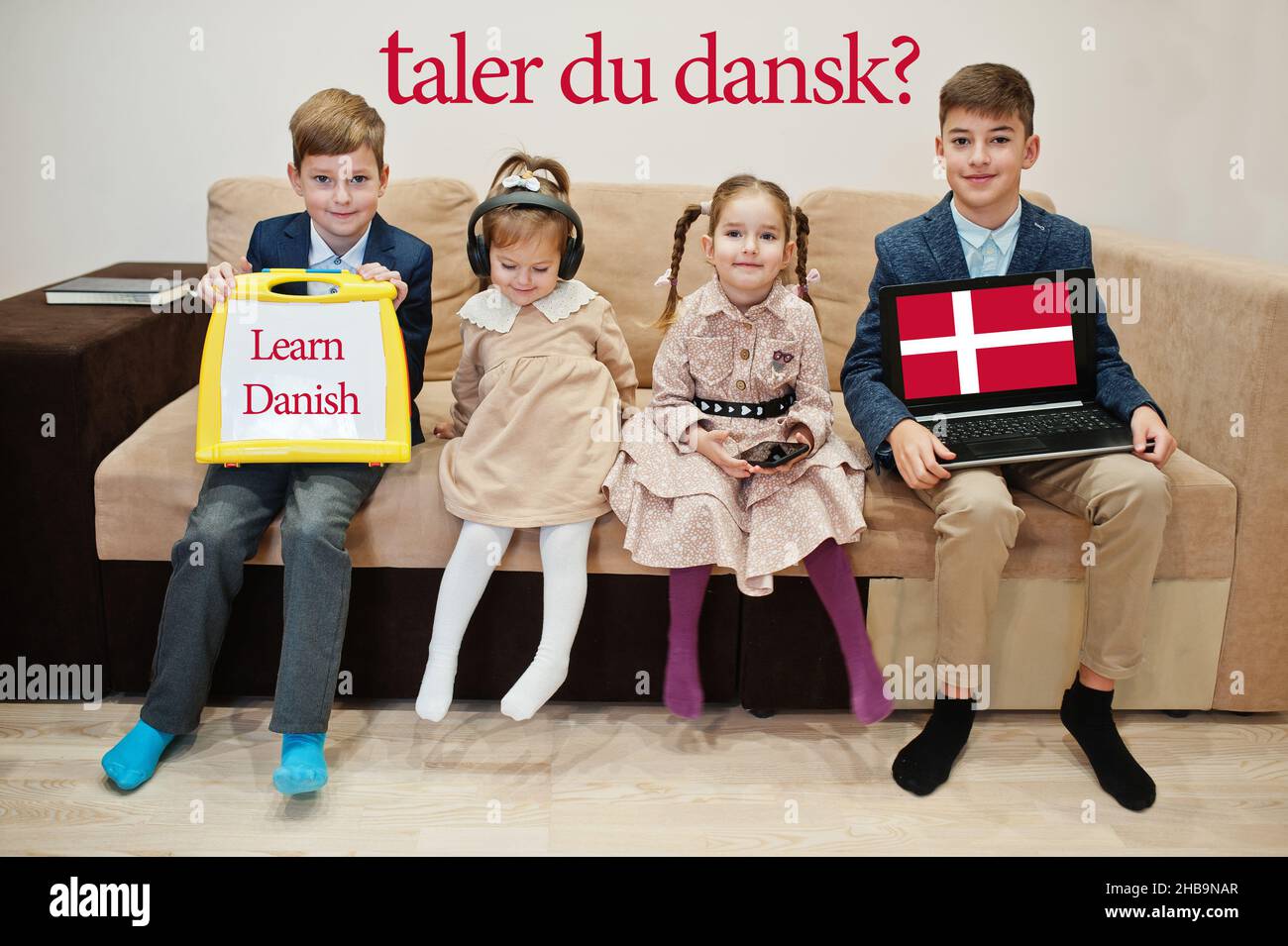 Four kids show inscription learn danish. Foreign language learning concept. Taler du dansk? Stock Photo