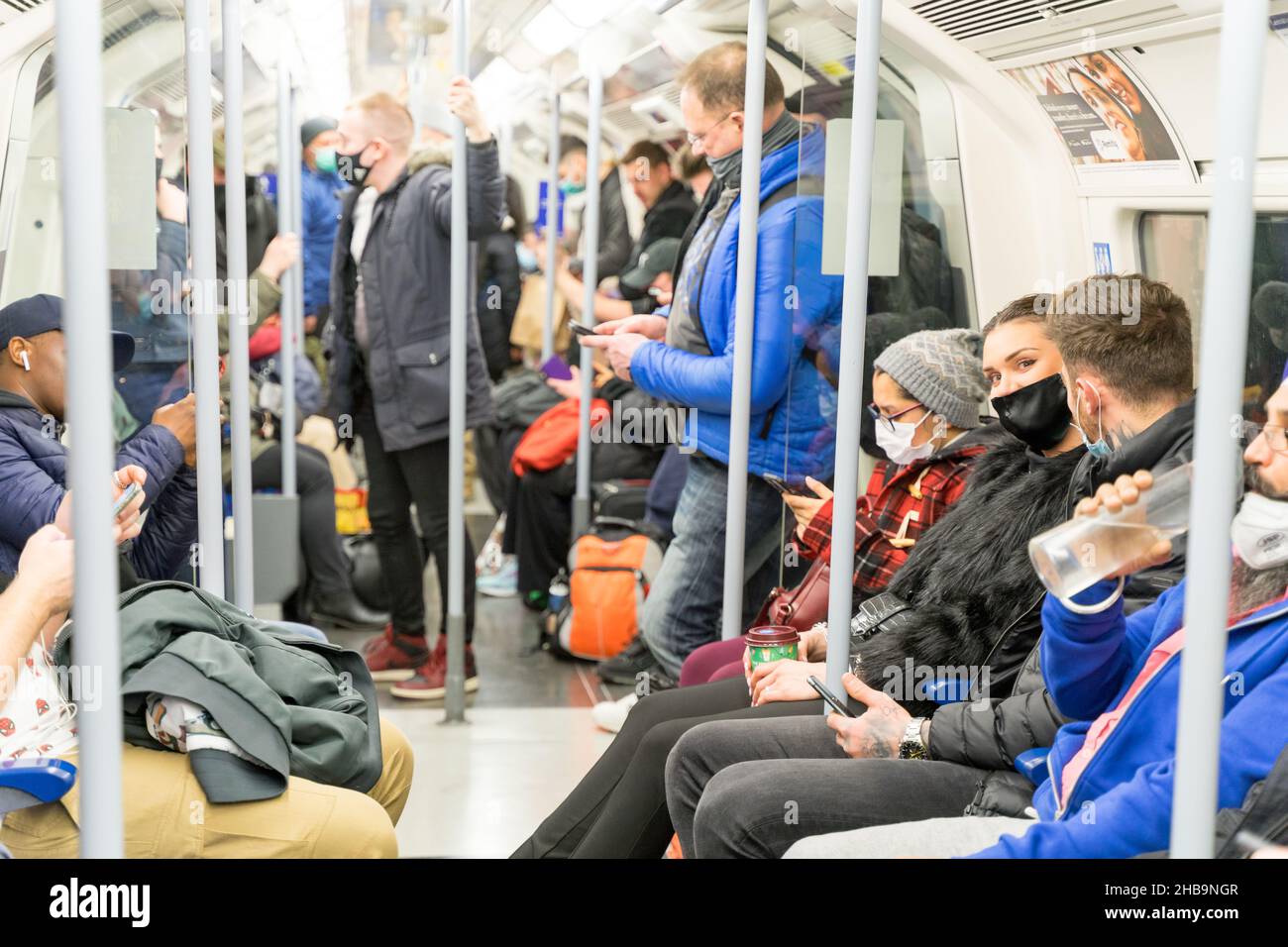 Passenger in face mask are seen wearing face mask in crowded Tube train