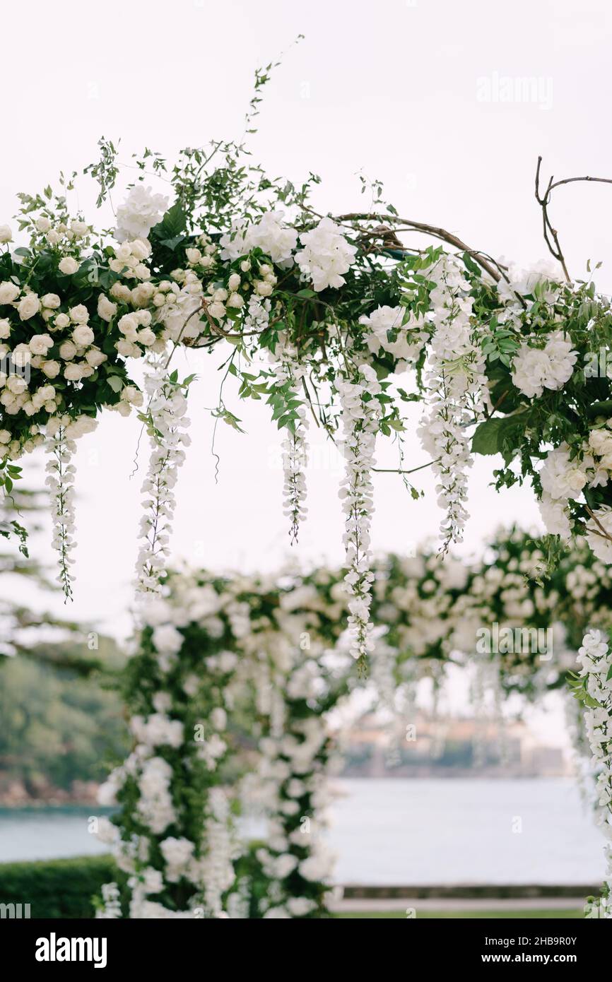 Wicker wedding arch decorated with roses, wisteria and green leaves Stock  Photo - Alamy