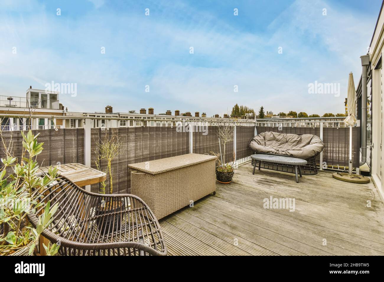 Cozy balcony with wicker chest and wicker chairs Stock Photo - Alamy
