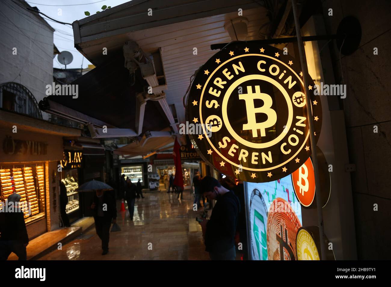 Istanbul, Turkey. 17th Dec, 2021. People are seen walking past the sign of  the bitcoin exchange office near the Grand Bazaar. (Photo by Hakan  Akgun/SOPA Images/Sipa USA) Credit: Sipa USA/Alamy Live News