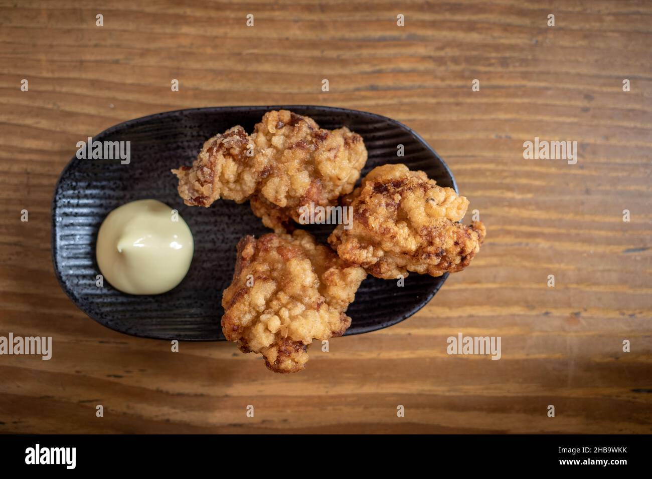 Karaage or Japanese fried chicken serve with mayo on wooden table in