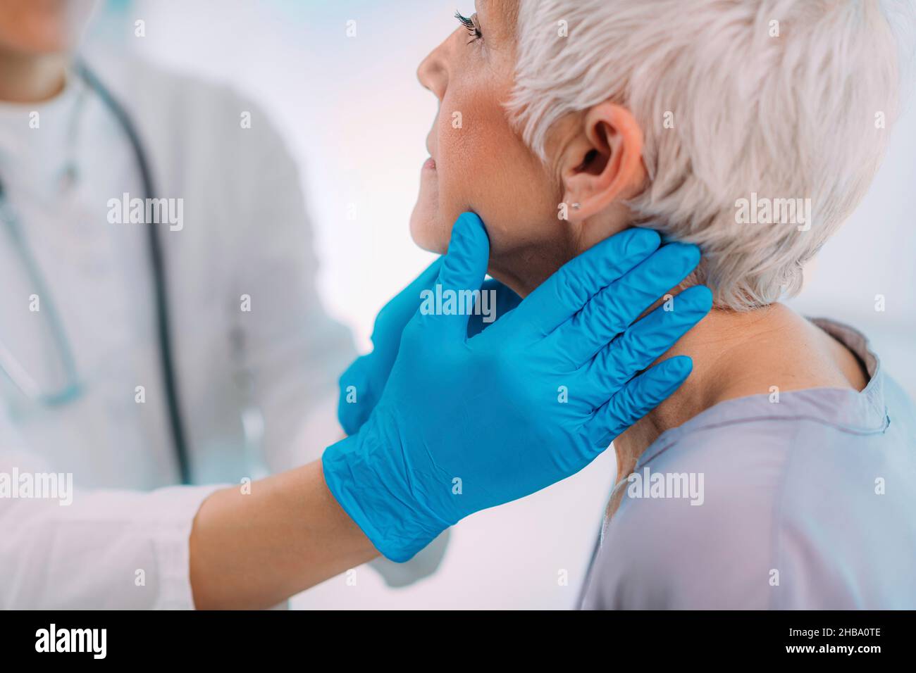 Doctor Examining A Senior Woman S Neck Stock Photo Alamy