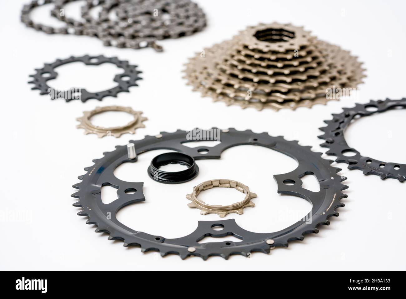 Gears, sprockets and chain of a mountain sports bike on a white