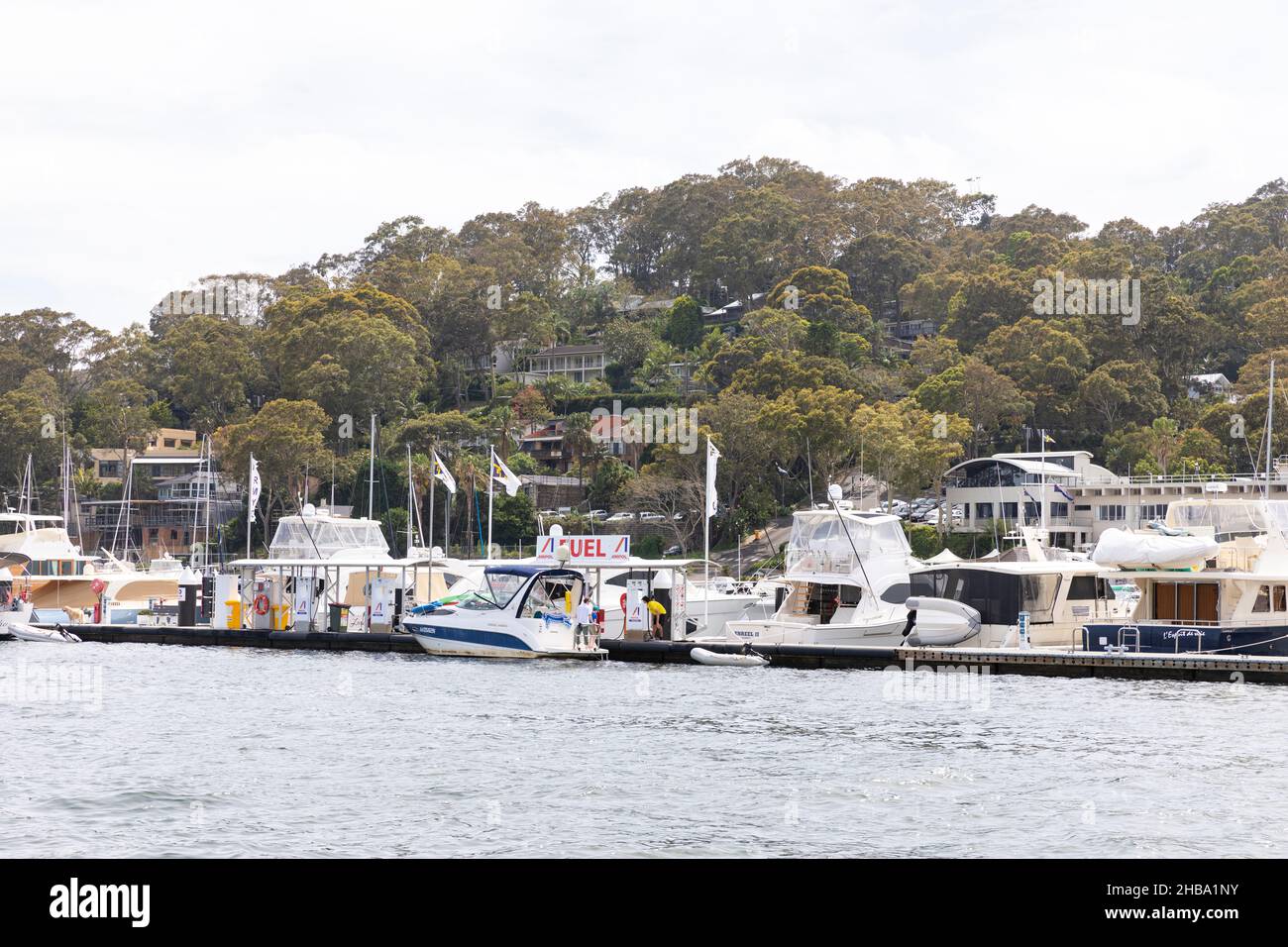 Royal Motor Yacht Club on Pittwater Sydney and a cruiser boat stops at the wharf to add fuel petrol to the boat,Australia Stock Photo