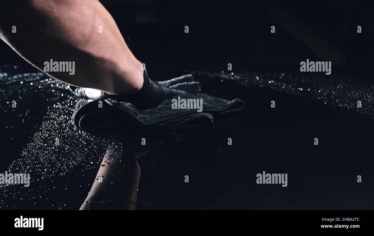 Using rag in palm of your hand, drops are removed from the car. Drop ...