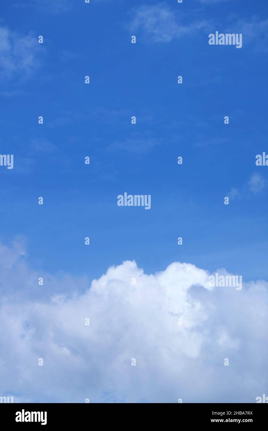 White cumulus clouds on bright blue sky Stock Photo