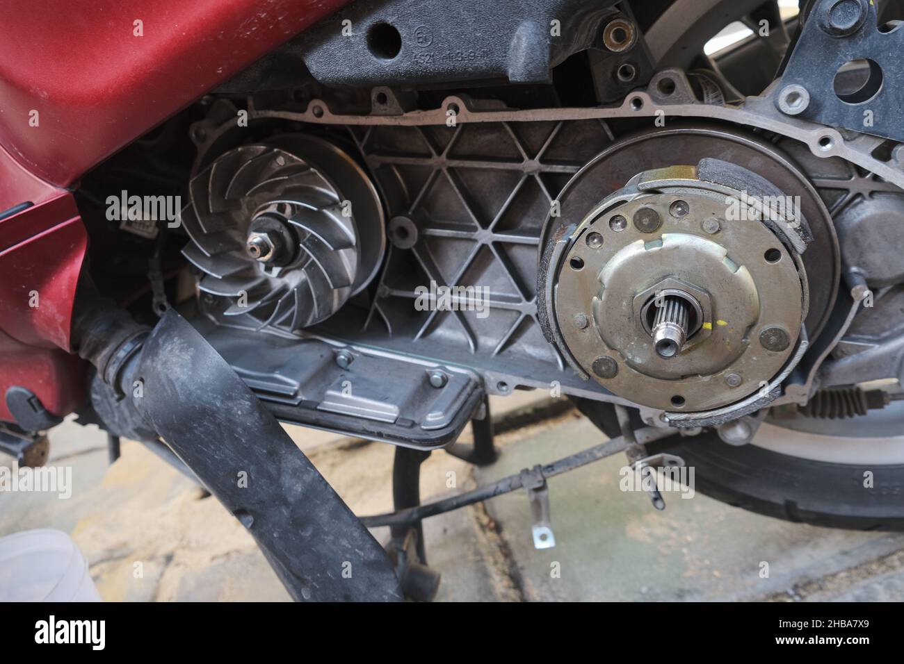 Scooter motorcycle CVT gear and clutch repair hand of mechanic close up