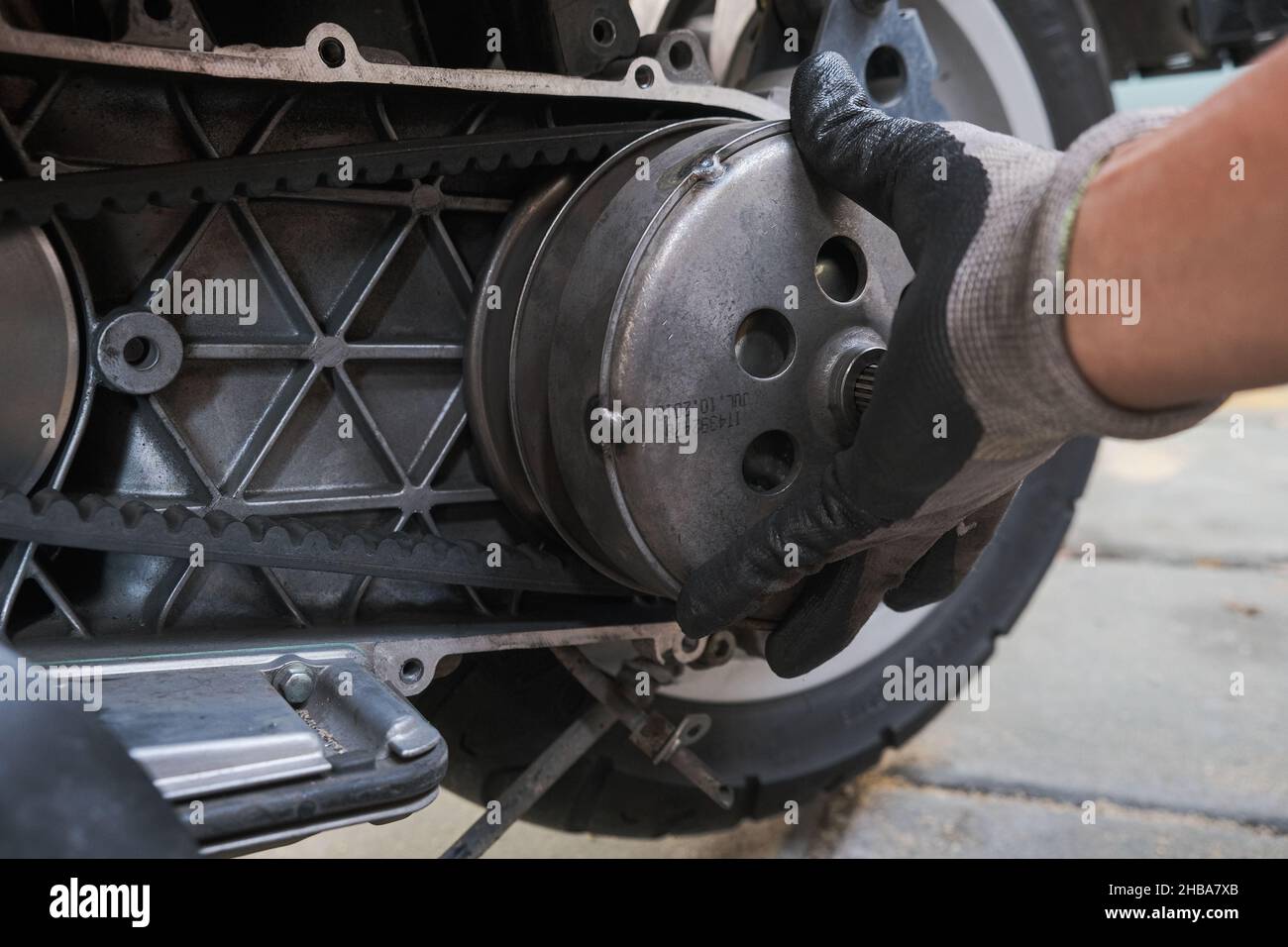 Scooter motorcycle and clutch hand of mechanic close up Stock Photo -