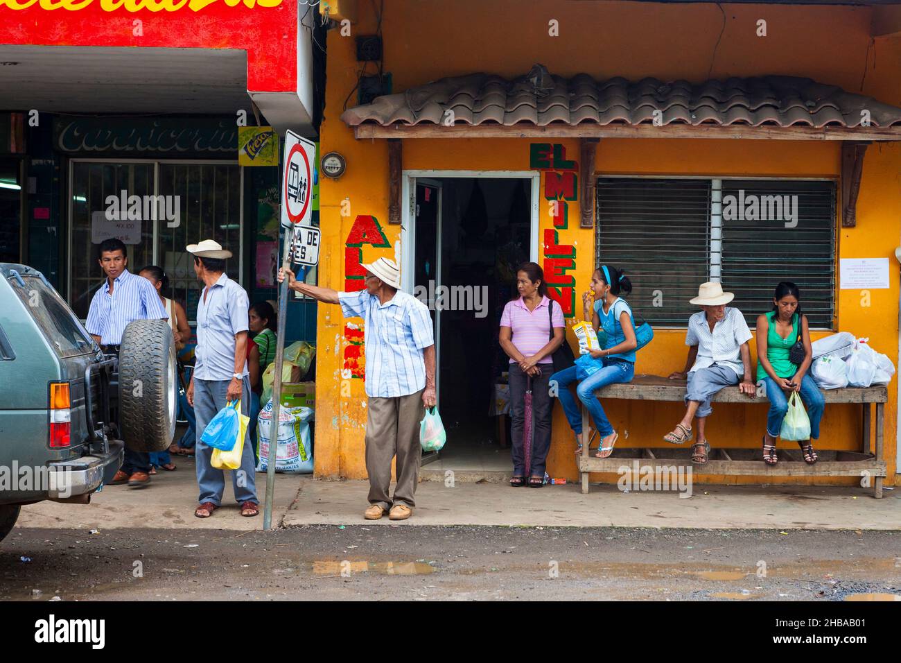 Panamanian people are waiting for the bus at the bus station in the town Ocu, Herrera province, Republic of Panama, Central America. Stock Photo