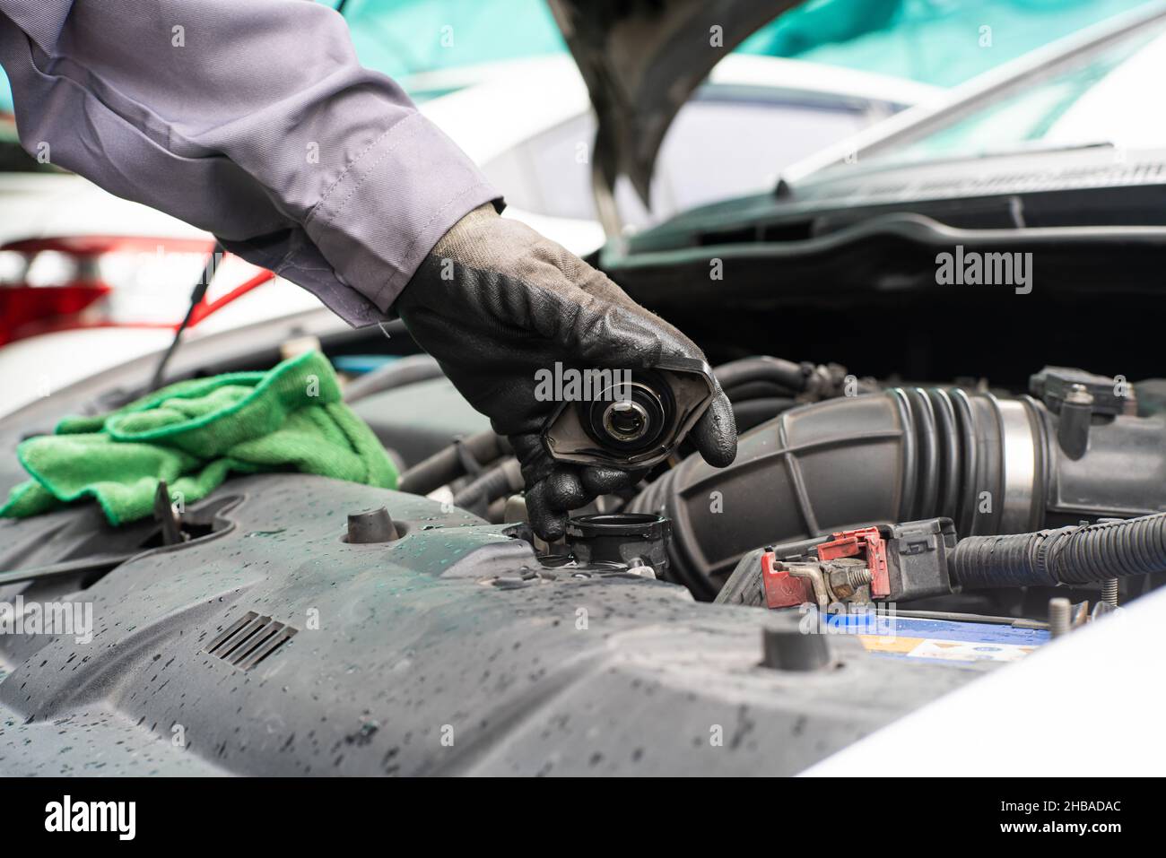 Mechanic man checking engine oil refill car maintenance close up engine Stock Photo Alamy