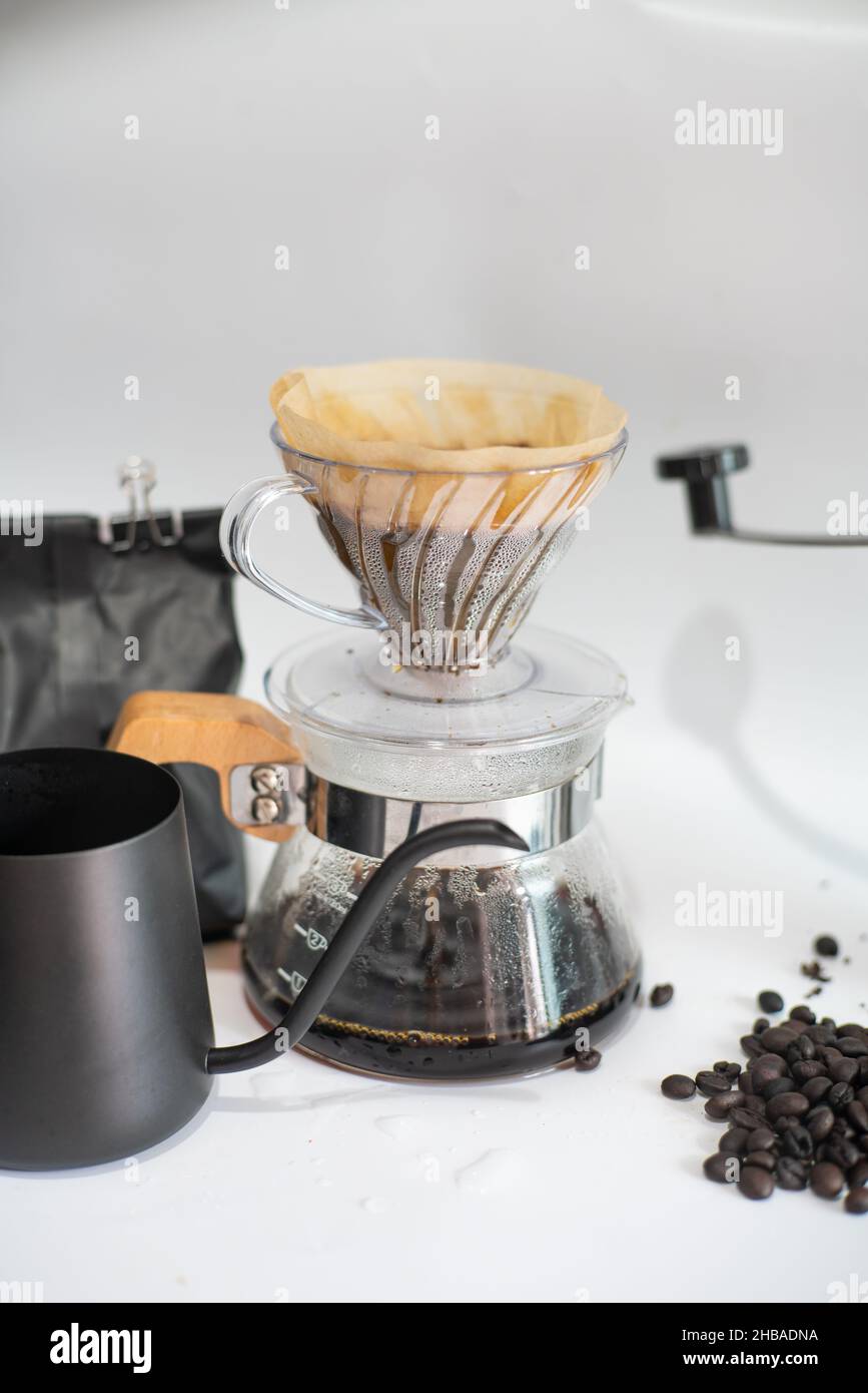 Drip brewing coffee on paper filtered pouring water over roasted with