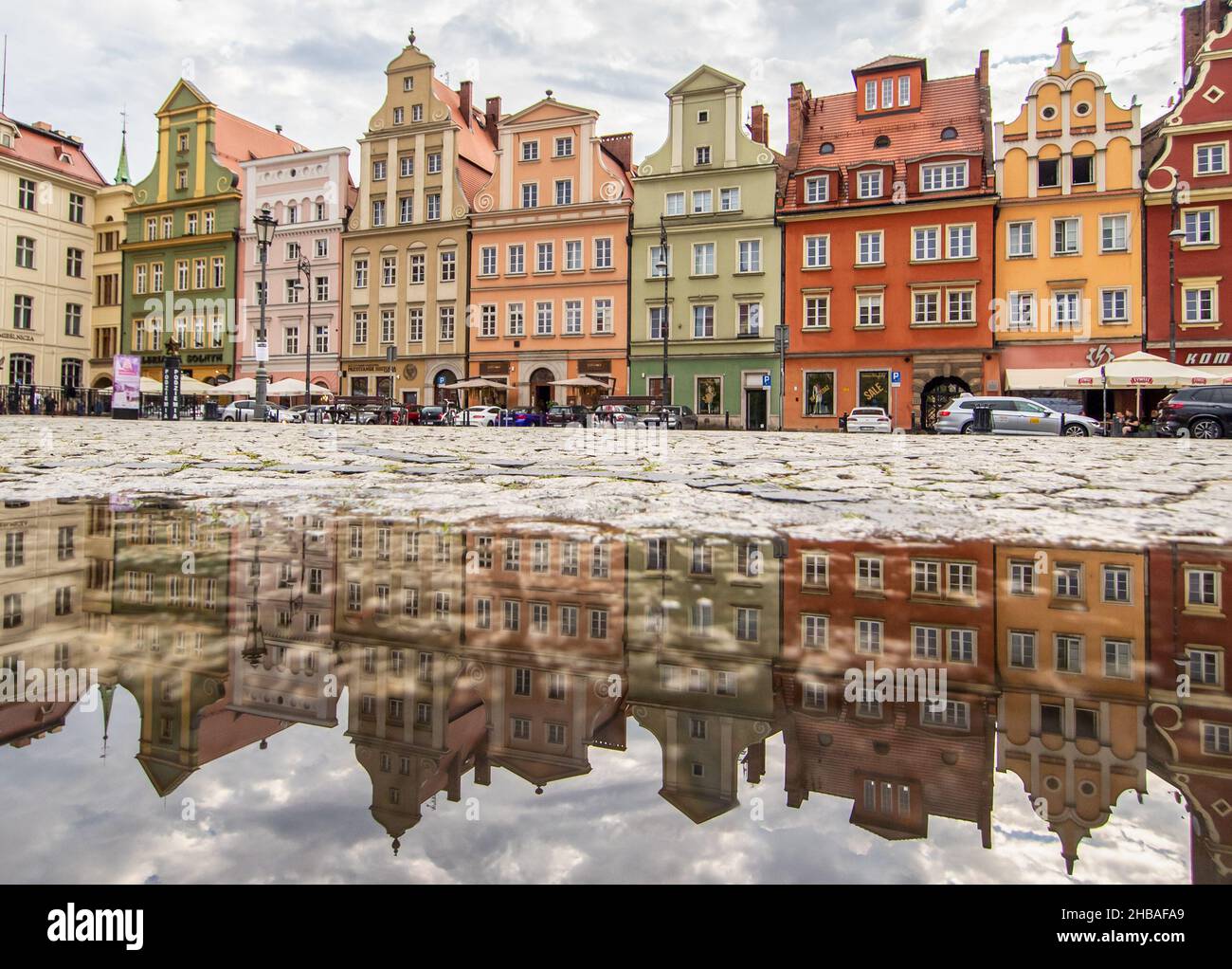 Due to the frequent rain, in Wroclaw you can easely find water pools, and use them for nice shots. Here in particular mirror effect in the Old Town Stock Photo