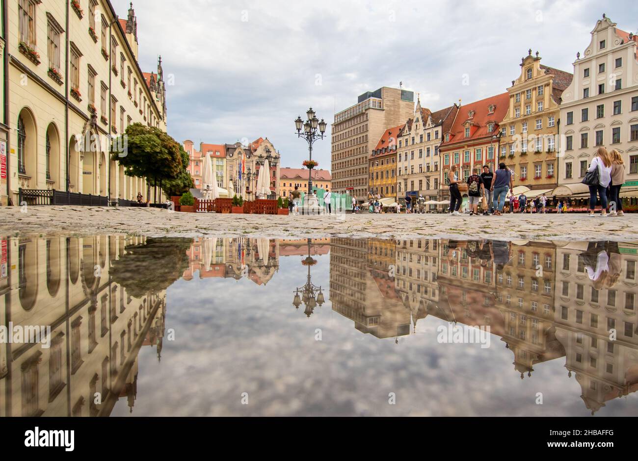 Due to the frequent rain, in Wroclaw you can easely find water pools, and use them for nice shots. Here in particular mirror effect in the Old Town Stock Photo