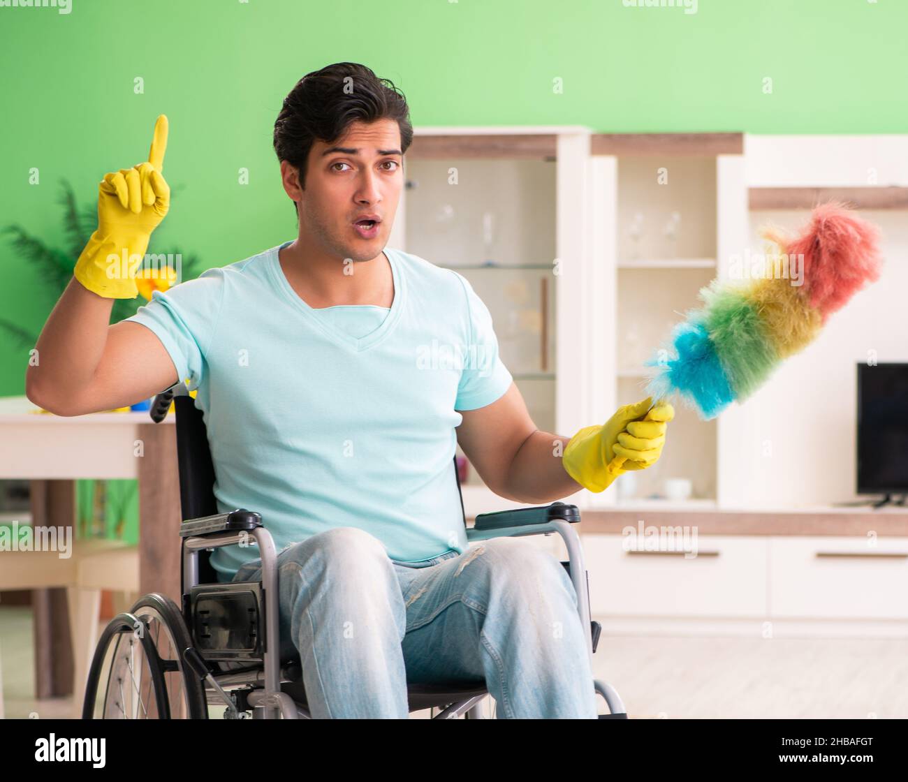 The disabled man on wheelchair cleaning house Stock Photo Alamy