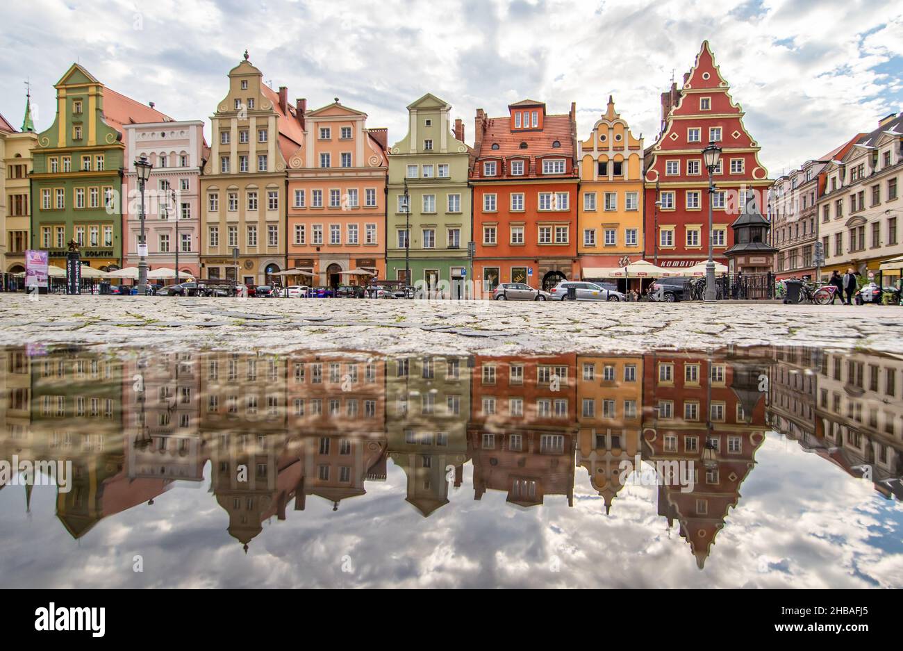 Due to the frequent rain, in Wroclaw you can easely find water pools, and use them for nice shots. Here in particular mirror effect in the Old Town Stock Photo