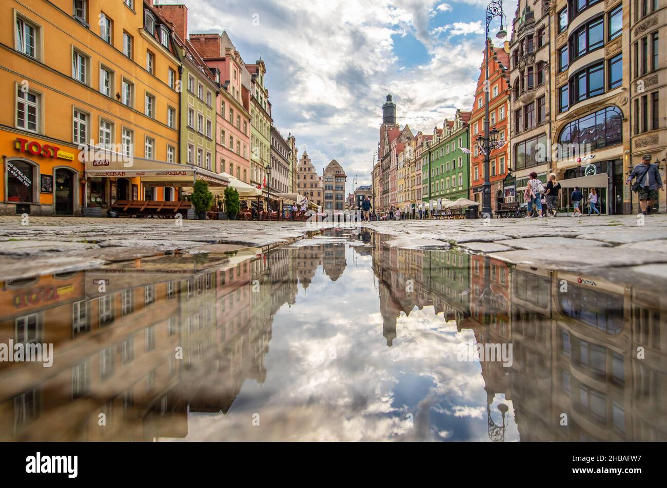 Due to the frequent rain, in Wroclaw you can easely find water pools, and use them for nice shots. Here in particular mirror effect in the Old Town Stock Photo