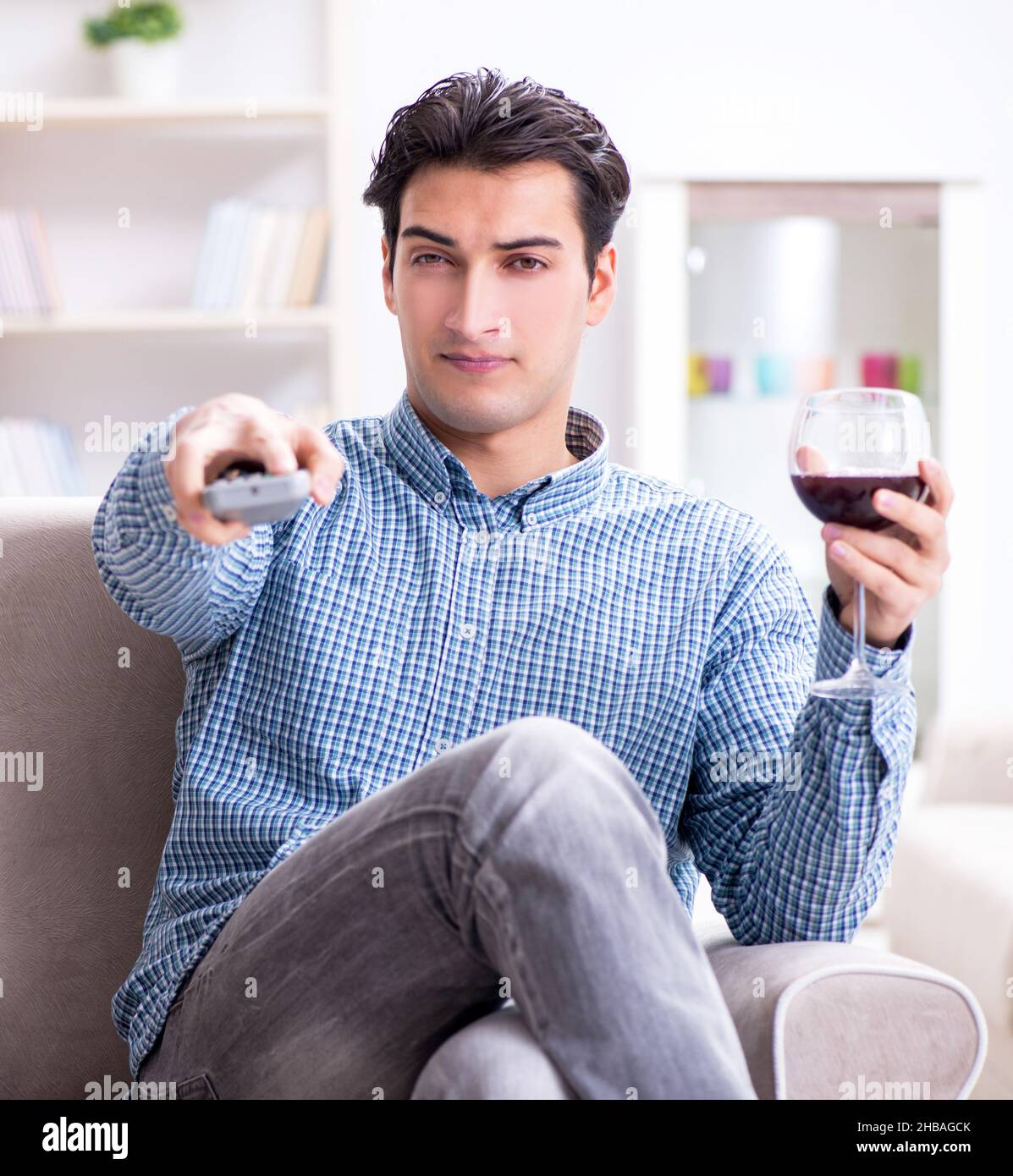 The young man drinking wine at home Stock Photo - Alamy