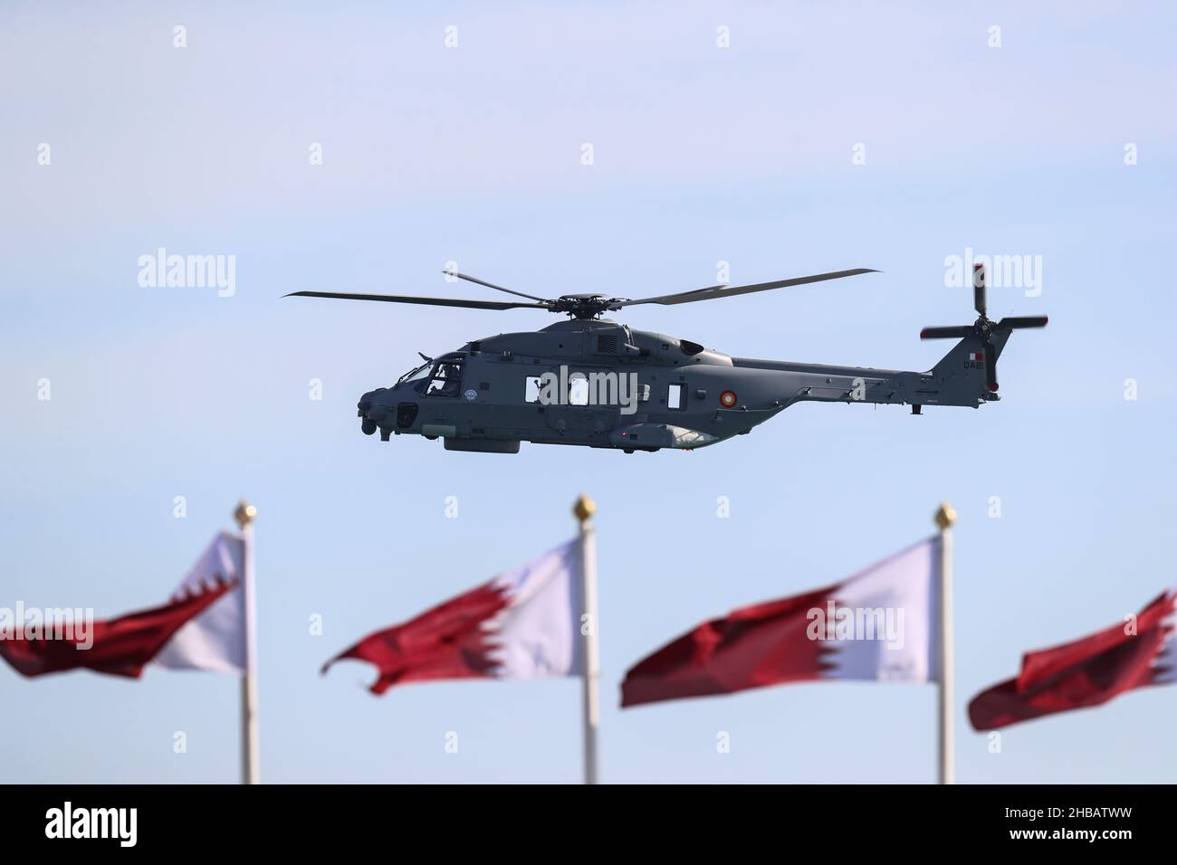Doha, Qatar. 18th Dec, 2021. An air force helicopter flies through the