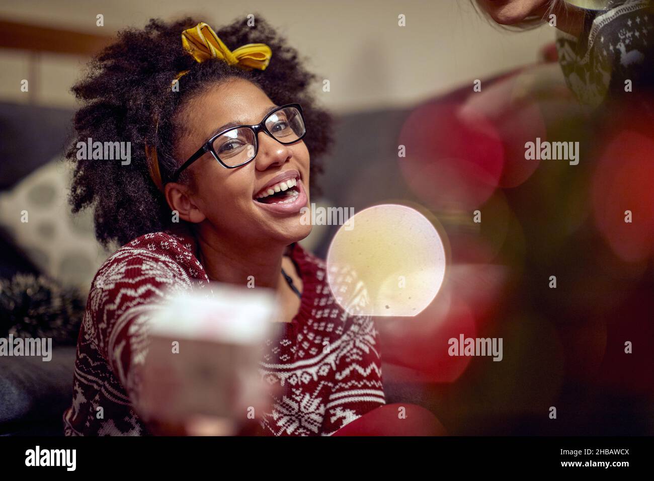 Portrait of a happy afro american woman eexchanging gifts Stock Photo