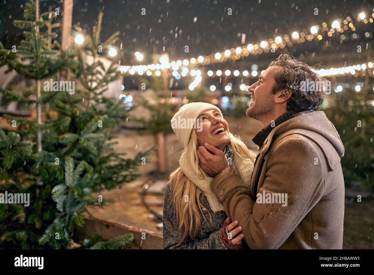 Smiling Couple choose the perfect Christmas tree Stock Photo