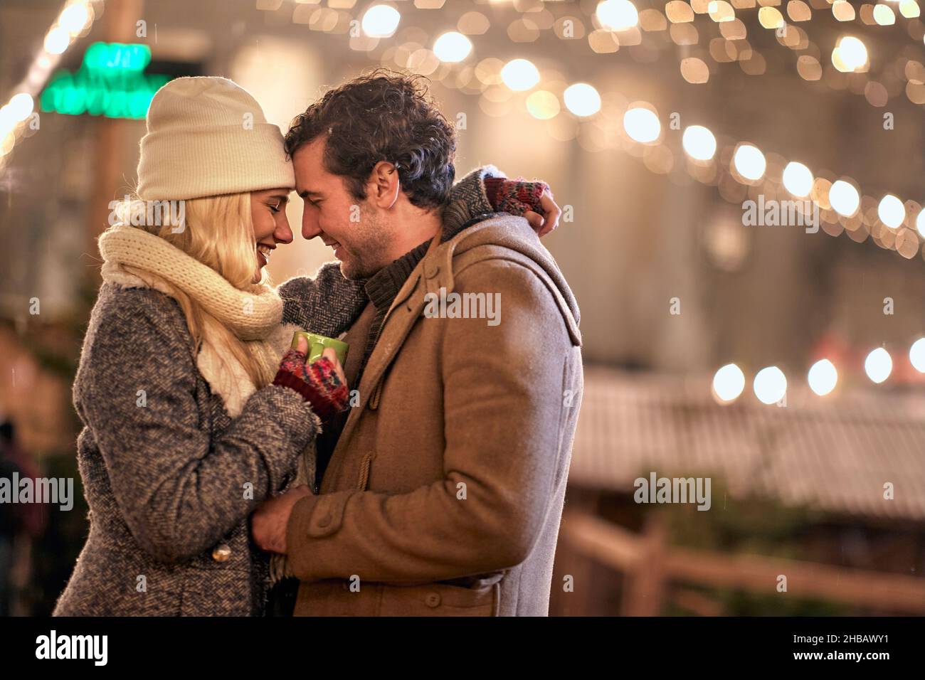 Joyful couple enjoying the winter night together; Festive concept Stock Photo