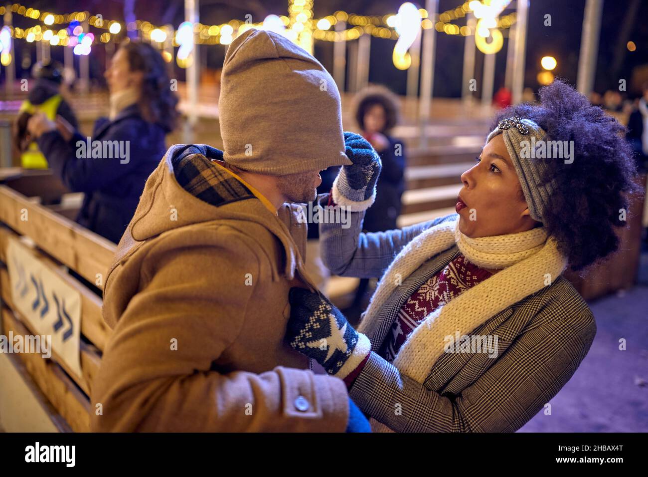 Happy multiethnic couple enjoying in the winter night together Stock Photo