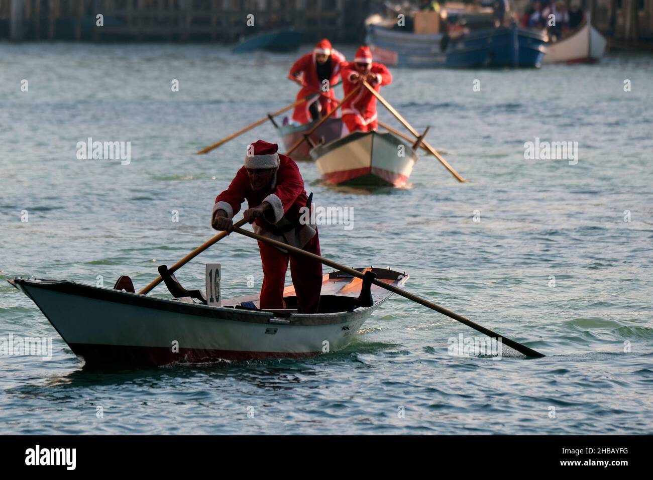 People dressed as Santa Claus row during a Christmas regatta in Venice, Italy December 17, 2017.(MvS) Stock Photo