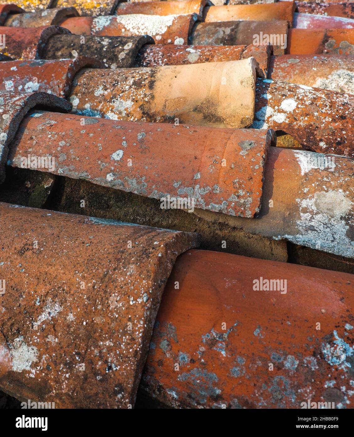 Close-up shot of old grungy dirty weathered rough red roof tiles texture Stock Photo