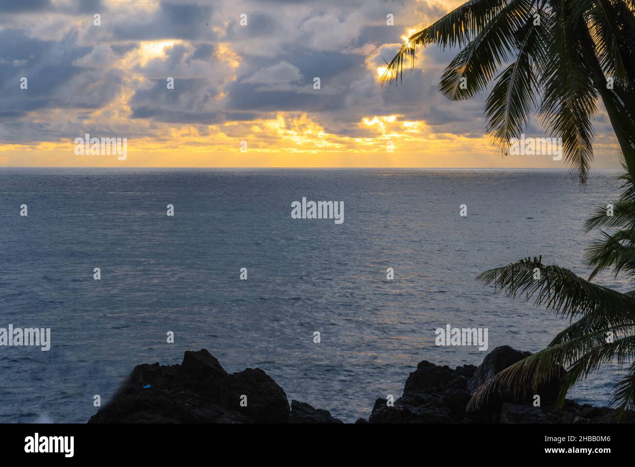 Beautiful sunset over the sea on tropical beach with palm tree and ...