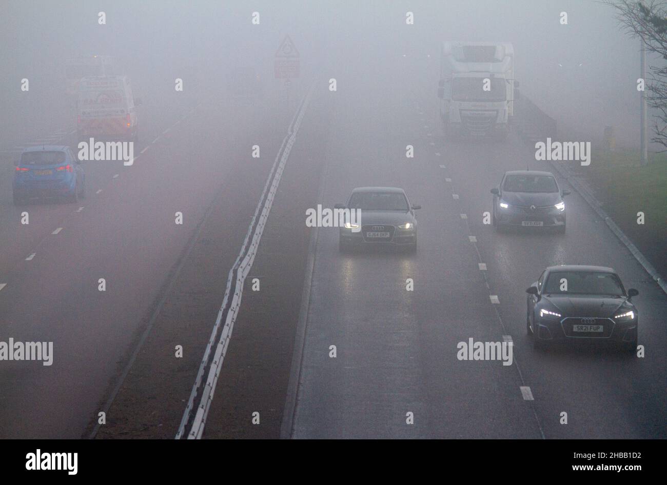 Dundee, Tayside, Scotland, UK. 18th Dec, 2021. UK Weather: On a cold winter morning with dense fog and mist, temperatures in North East Scotland reached 4°C. On a foggy December morning in Dundee motorists are driving cautiously along the Kingsway West dual carriageway due to poor visibility. Credit: Dundee Photographics/Alamy Live News Stock Photo