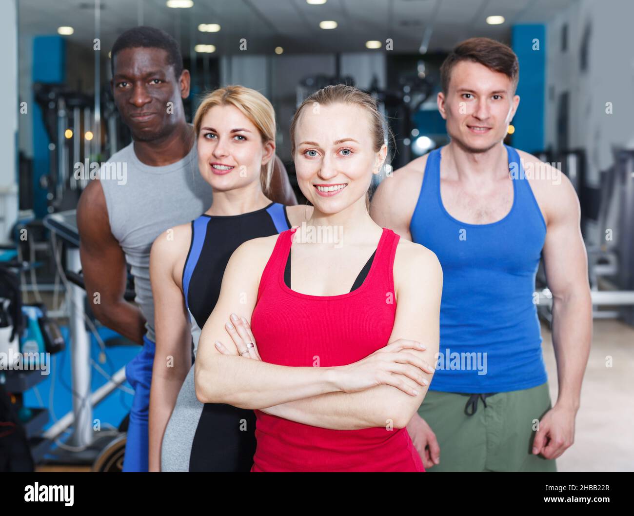 Young people taking break during workout at gym Stock Photo