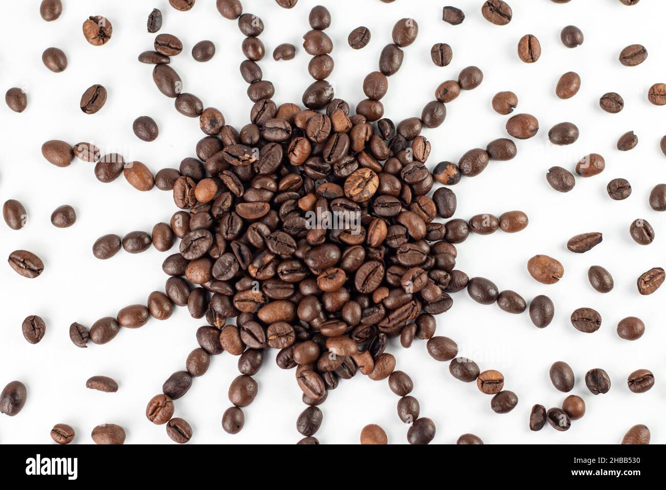Sun symbol made from roasted coffee beans on the white background. Stock Photo