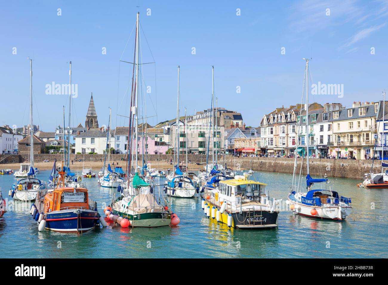 Ilfracombe beach and The Quay behind the fishing boats and yachts in the harbour in the town of Ilfracombe Devon England UK GB Europe Stock Photo
