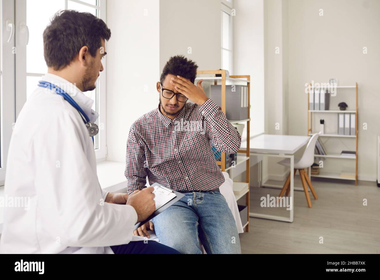 Unhealthy man suffer from headache consult with doctor Stock Photo - Alamy