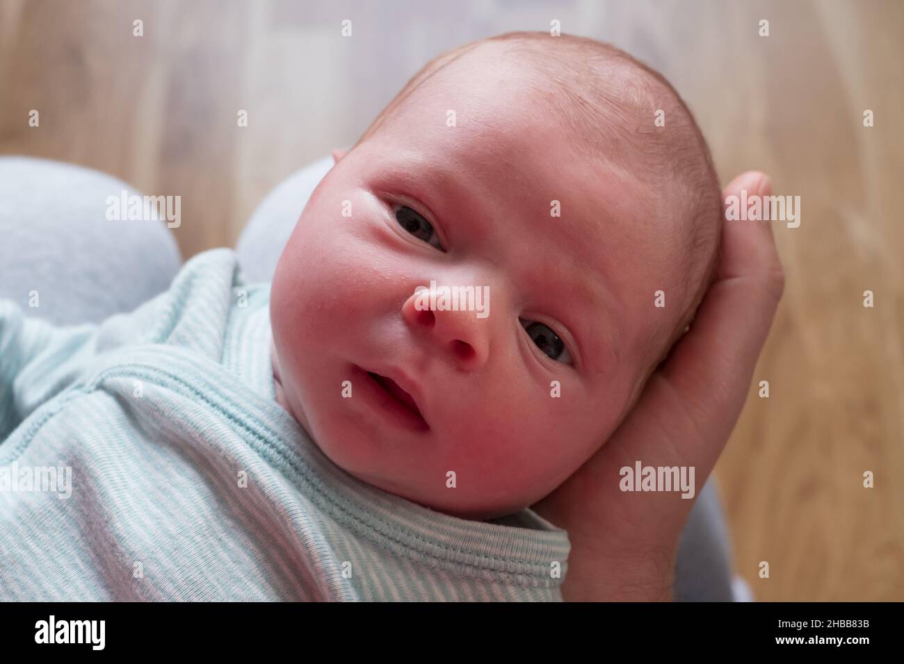 Portrait of small caucasian newborn girl looking at camera Stock Photo