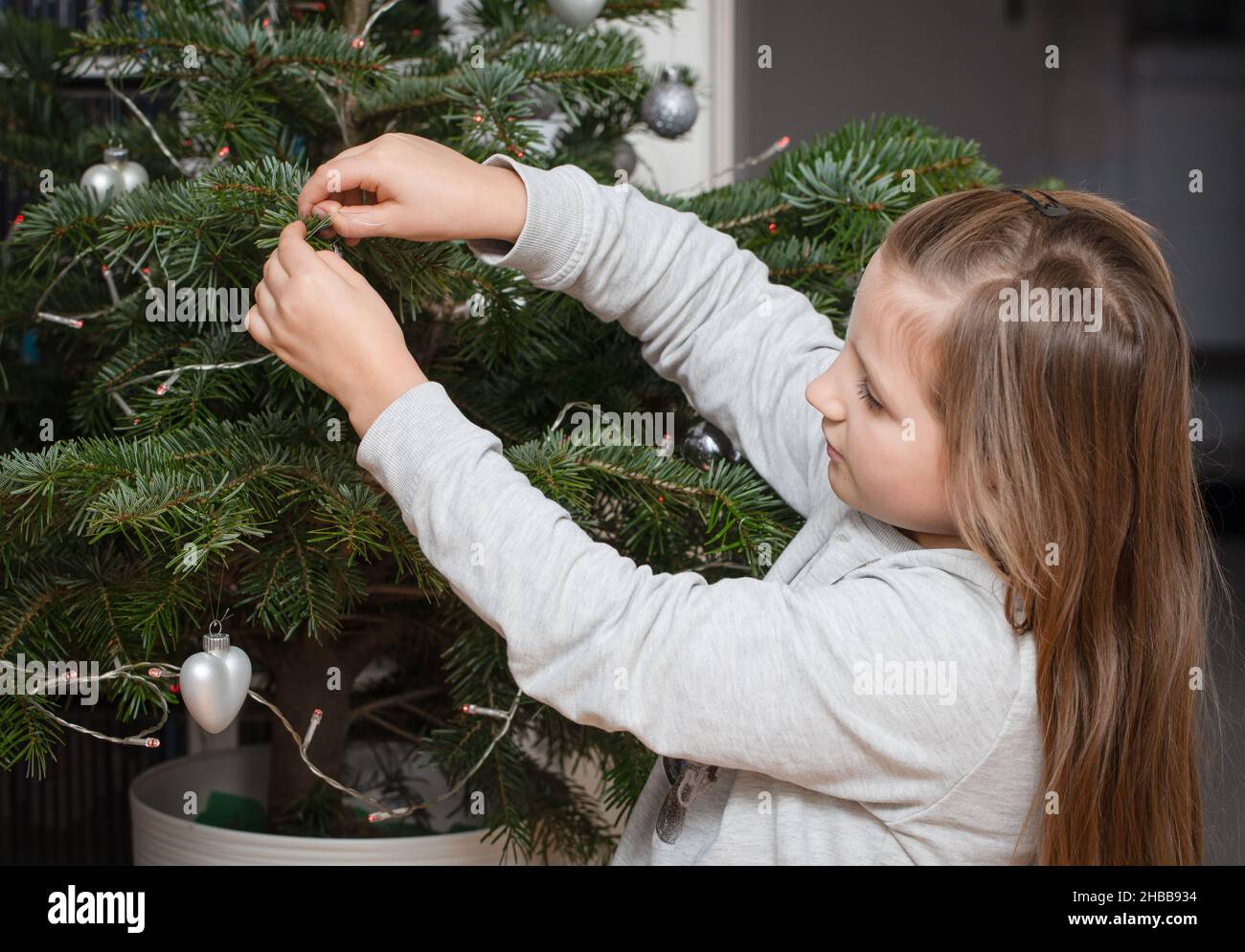 A girl dressing a Christmas tree Stock Photo Alamy
